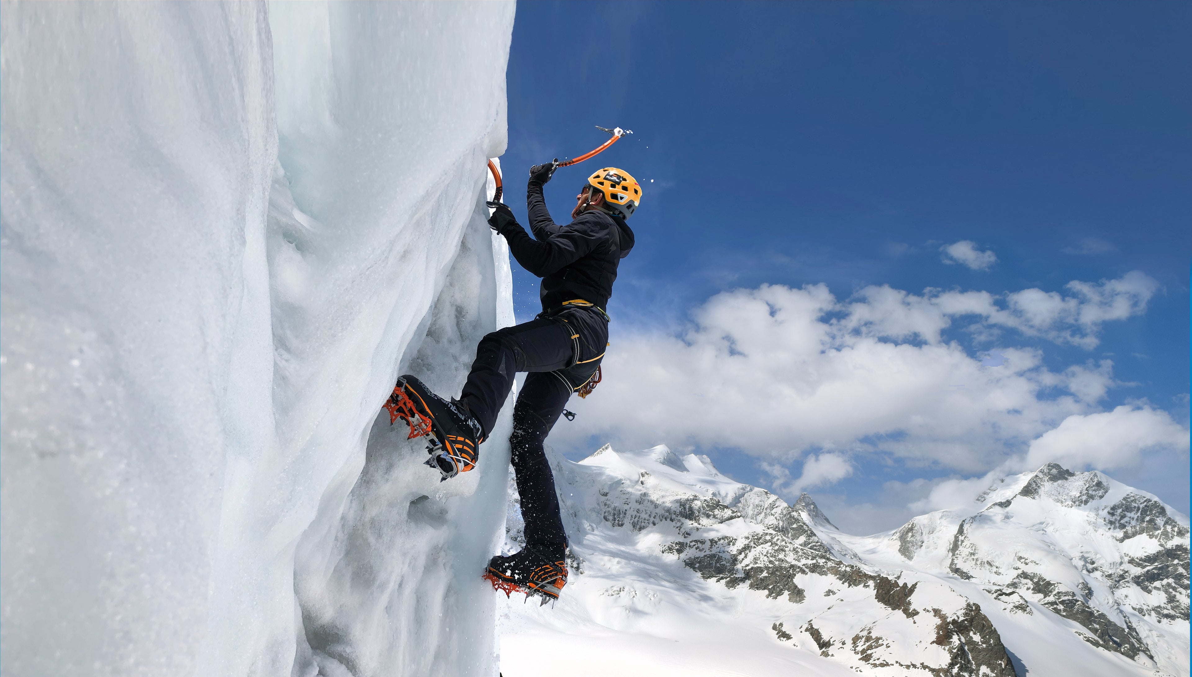 A person ice climbing on a sunny day. 