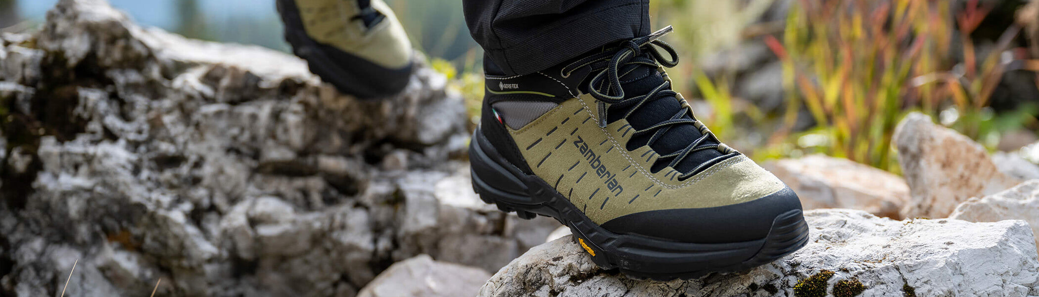 A person wearing Zamberlan Circe Mid GTX WNS women's hiking boots walking across rocks. 