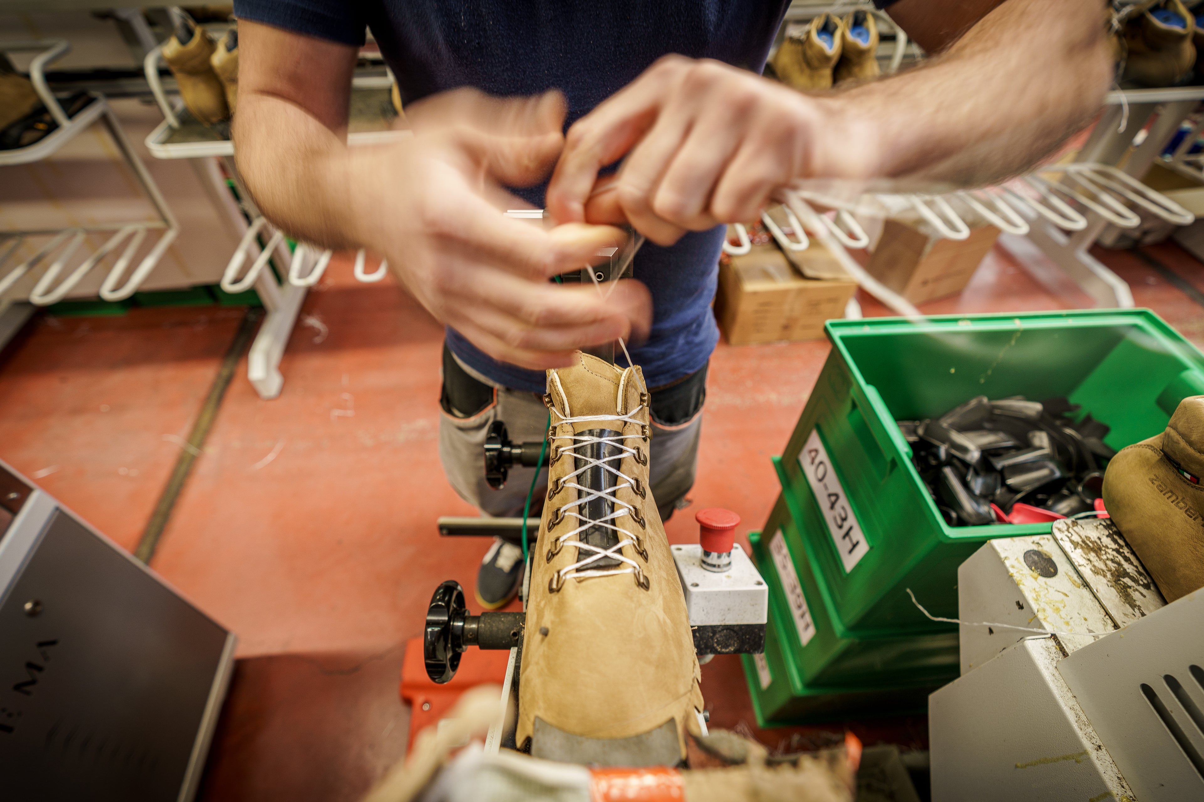 Zamberlan factory employee tying shoelaces. 