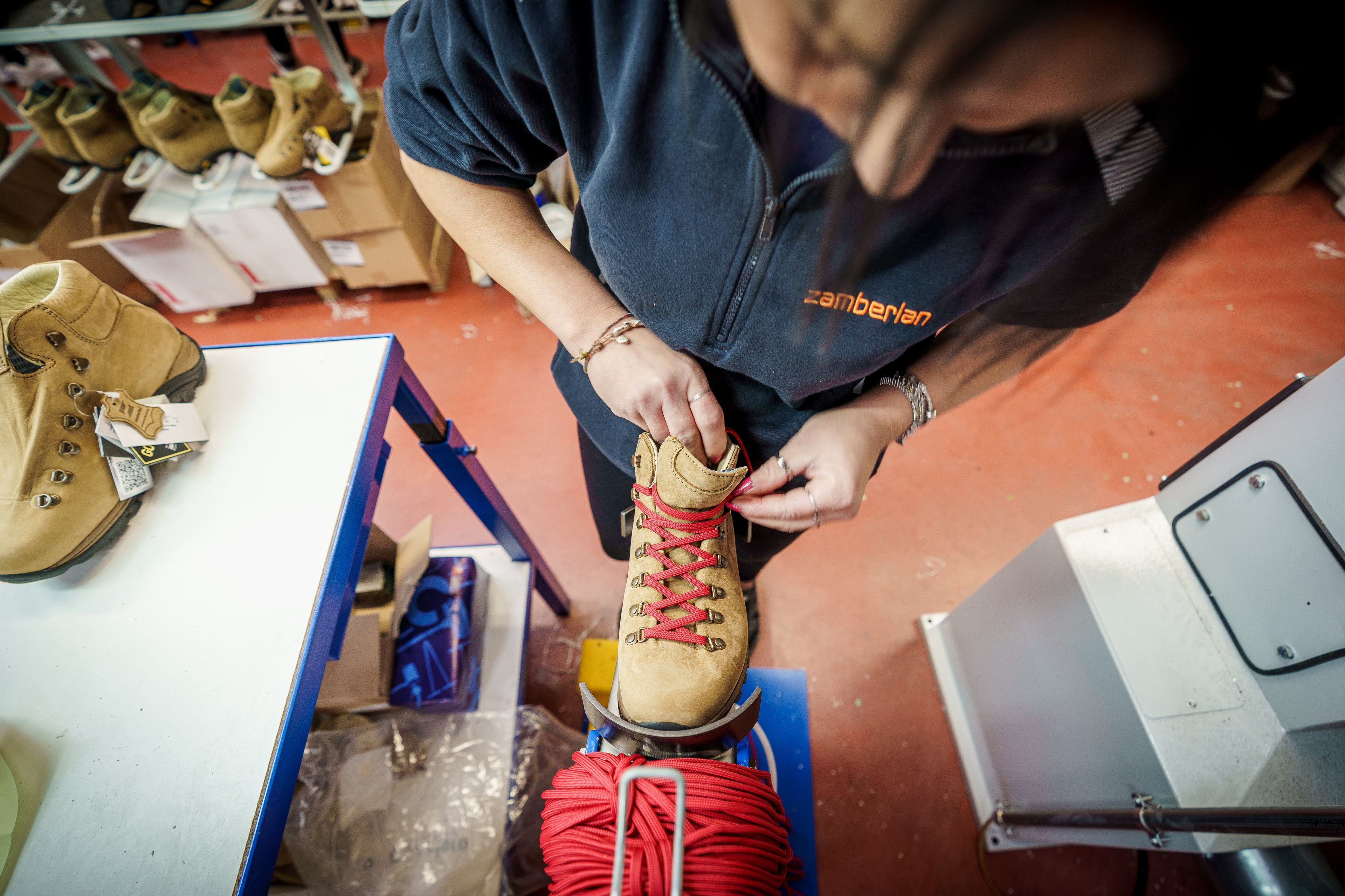 Zamberlan employee hand lacing Trail Lite Evo GTX women's  hiking boot in the factory. 